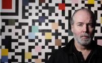 Portrait of Douglas Campbell Coupland: Artist in front of a QR Code painting. Courtesy Time Out Shanghai (c.2012).